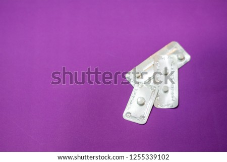 Emergency contraception (morning after pill) packs on purple background. Royalty-Free Stock Photo #1255339102