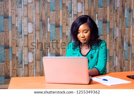 A young African Girl Working on her Laptop