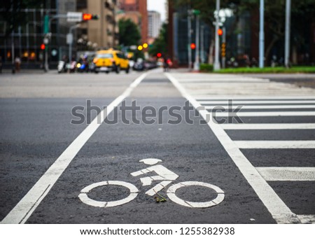 Bicycle lane with bicycle white road sign. Sustainable lifestyle concept.  Royalty-Free Stock Photo #1255382938