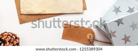 Christmas composition. Christmas gifts, old vintage envelope and paper, pine cone. Top view, flat lay, copy space, mockup, panoramic real photo

