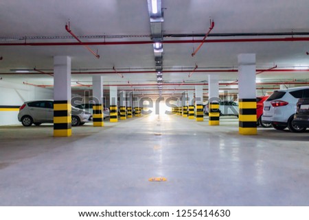 Underground parking garage with various cars. 