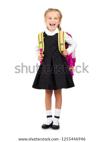 Little smiling blond girl in school uniform with pink school bag isolated on the white background