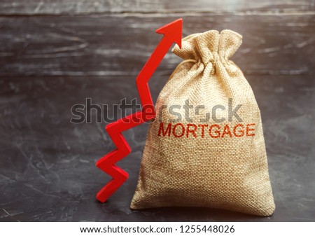 A bag with money and the inscription Mortgage and up arrow. Raising mortgage rates and tax. The increase in interest charges. Loan for housing, apartment and property. Increased demand for mortgages