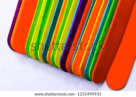 Various colors on ice cream sticks with white backgrounds
