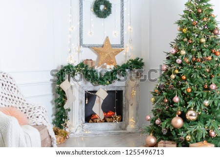 Christmas interior in the living room-fireplace, Christmas tree and chair