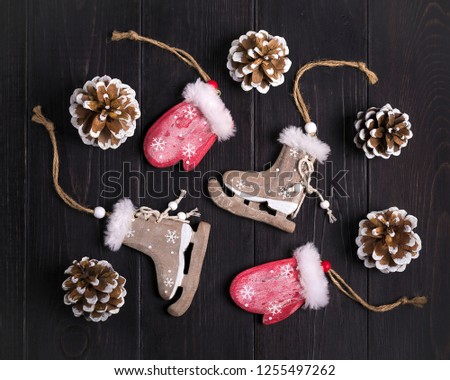 Merry Christmas card. New year decor-deer, cones, mittens, skates, tangerines, snowflakes on wooden background Flat lay Rustic style Mock up