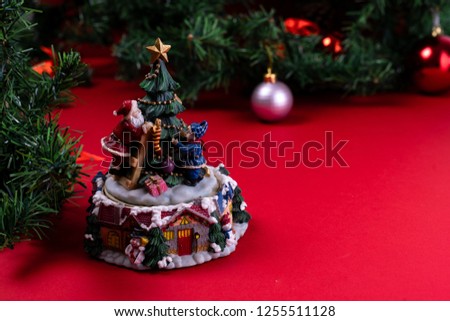 Old Christmas music box spinning, garland and tree, ornaments in background, close up
