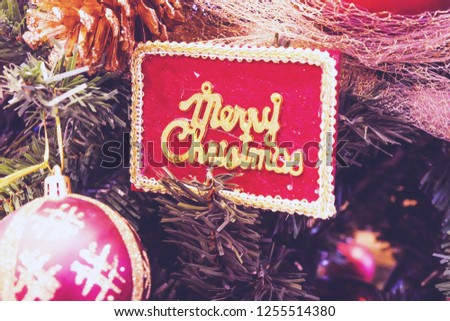 Christmas sign on Christmas tree.