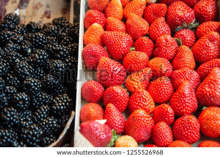 Red strawberries and blackberries at the market in Malaga.
