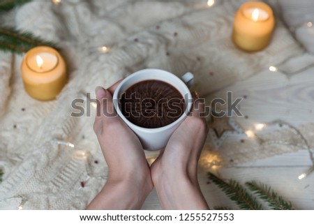 Famale hands holding a mug with cacao. Winter and Christmas home time concept. Lifestyle.