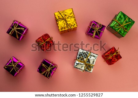 Christmas boxes with a surprise on a pink background. Merry Christmas.