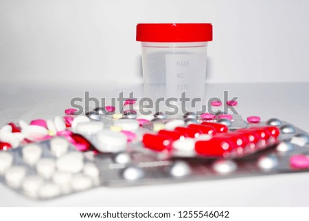 tests, a jar for tests on the background of pills and medicines for the hospital