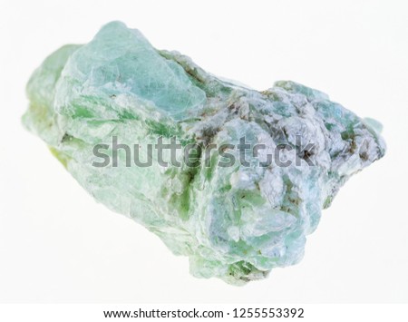 macro photography of natural mineral from geological collection - rough green talc stone on white background Royalty-Free Stock Photo #1255553392