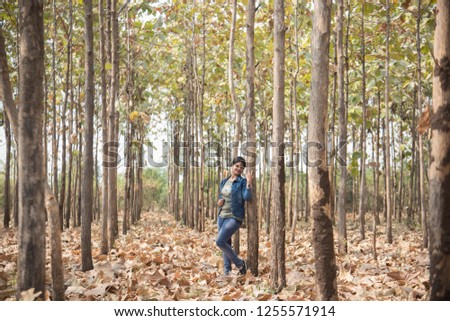 Beautiful young girl in forest, Happy woman enjoying nature.