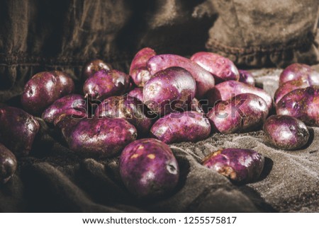 Some are pure pink potatoes on sacking
