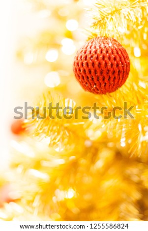 Glittering Bauble with Glowing Sparkling Gold defocused Light (bokeh) Illumination background with decorated Christmas Tree. Special Holidays, Festival design decoration, New Year Celebration, Party.
