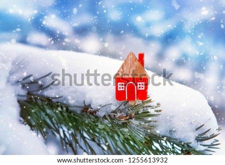 Christmas toy house on snowy natural background. festive winter season concept. Christmas and new year holiday. symbol of cozy, loving family home. construction, sales, rental concept.