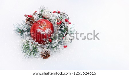 Christmas apple and festive decor on snow, abstract white background. Christmas and New year Holidays. winter season. copy space. template for design