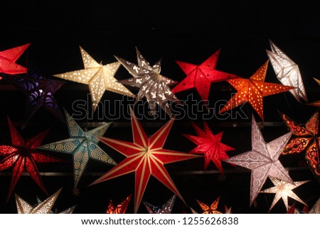 Colorful christmas decoration. Stars handcrafted by paper, electric enlightened by led