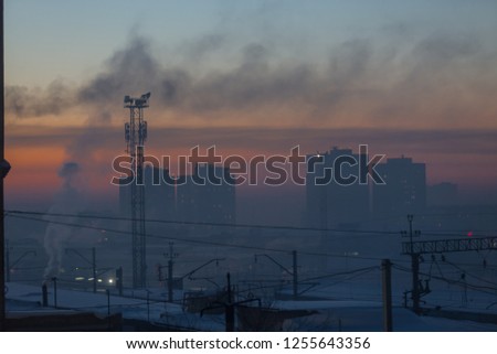 Sunset colored the sky in different colors. Smog over the city in winter. 