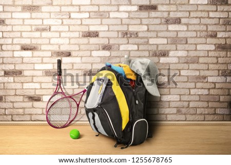 Outdoor backpack with clothes on a brick wall background