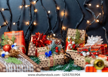 Christmas presents with branches Christmas tree on a snow. Christmas gifts on bokeh background