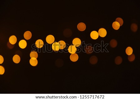 Abstract Gold bokeh sparkle on black background. Lights blurred bokeh  for christmas design