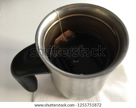 Tea bag in mug top down view white background