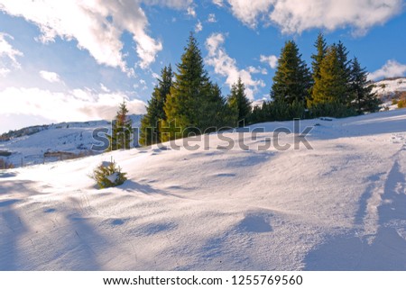 winter mountain landscape with snow and blue sky with clouds