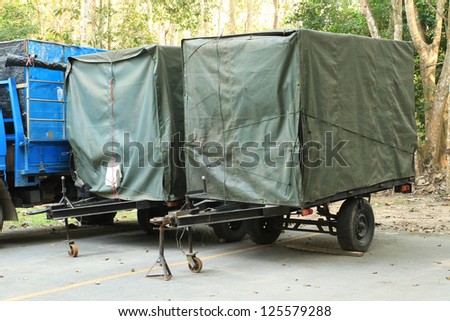 Small trailer in canvas cover Royalty-Free Stock Photo #125579288