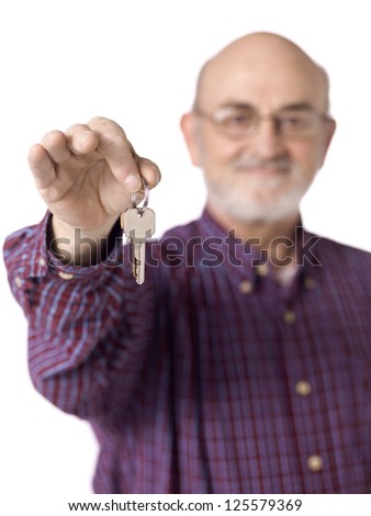 Portrait image of an old man holding a key against white background