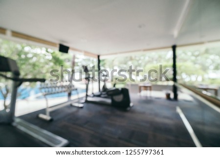 Abstract blur and defocused fitness equipment interior of gym room for background