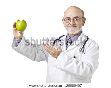 Smiling doctor presenting a green apple on his hand isolated in a white background