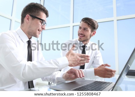 Businessmen wearing suits shaking hands