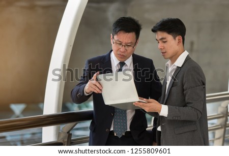 Two Businessman are working on the train station.