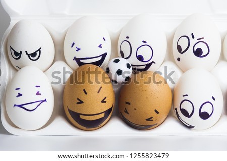 the fans. eggs with funny faces. eggs and ball. photo for your design