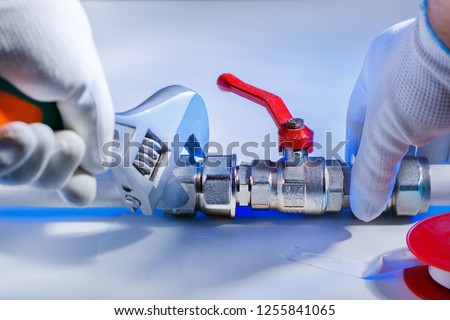 plumber at work with tools plumbing. repair concept. Royalty-Free Stock Photo #1255841065