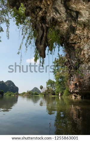 Vertical picture from inside of huge cave. Amazing view of trees and river close to Sadan Cave in Hpa-An, Myanmar