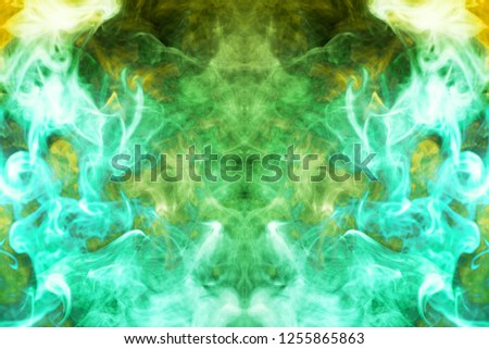 Thick colorful green and yellow smoke  in the form of a butterfly on a black isolated background. Background from the smoke of vape. Mocap for cool t-shirts

