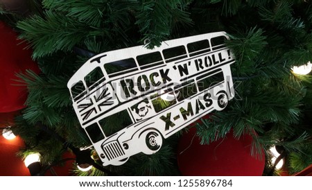 Background Double-Decker bus Rock 'N' Roll X-Mas beautiful decorated plywood+lights hanging in Christmas Tree and Happy New Year.