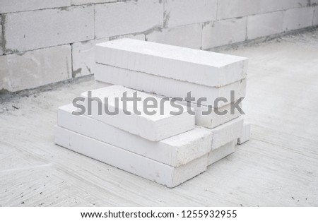 White autoclaved aerated concrete stack at a construction site.