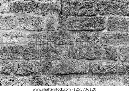 Black and white background of ancient stone wall. Texture of old brick. Monochrome.