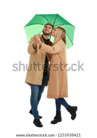Full length portrait of beautiful couple with umbrella, isolated on white