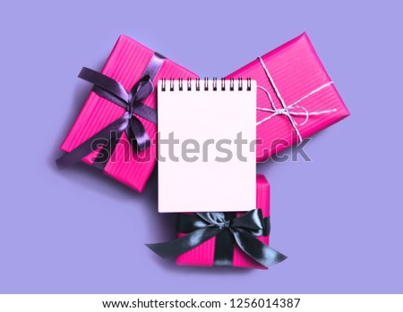 Minimal Christmas background with present gift boxes and empty notebook. copyspace for text.