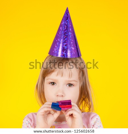 closeup image of the pretty little girl in the birthday cap