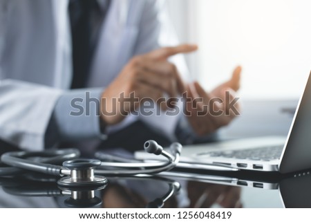 Telemedicine, Medical online, e health concept. Doctor video chat with patient via laptop computer, mobile health application. Doctor video conferencing, cropped image. Royalty-Free Stock Photo #1256048419