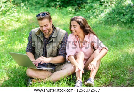 Nature best workspace. Couple youth spend leisure outdoors with laptop. Modern technologies give opportunity to be online and work in any environment conditions. Man and girl looking at laptop screen.