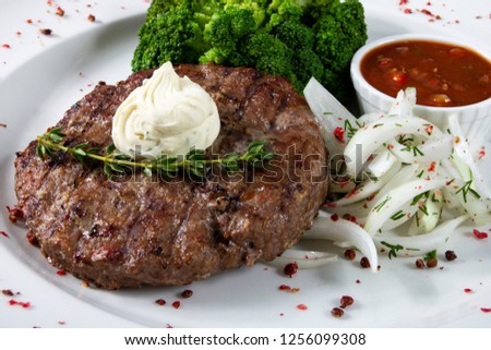 Steak rectangular with bow and sauce on white background
