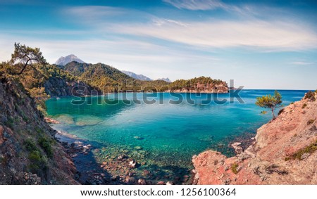 Marvelous Mediterranean seascape in Turkey. Sunny view of a small azure bay near the Tekirova village vith Mt. Tahtali on background. Beauty of nature concept background.