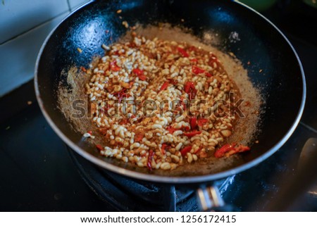 Stock Photo - Cooking egg ants fried with basil